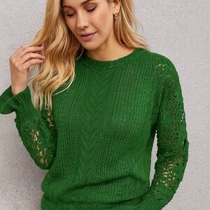 Green knit sweater with decorative crochet sleeves